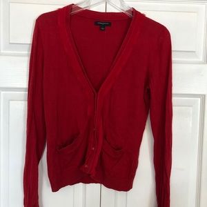 Red cardigan with chiffon detail and pockets.